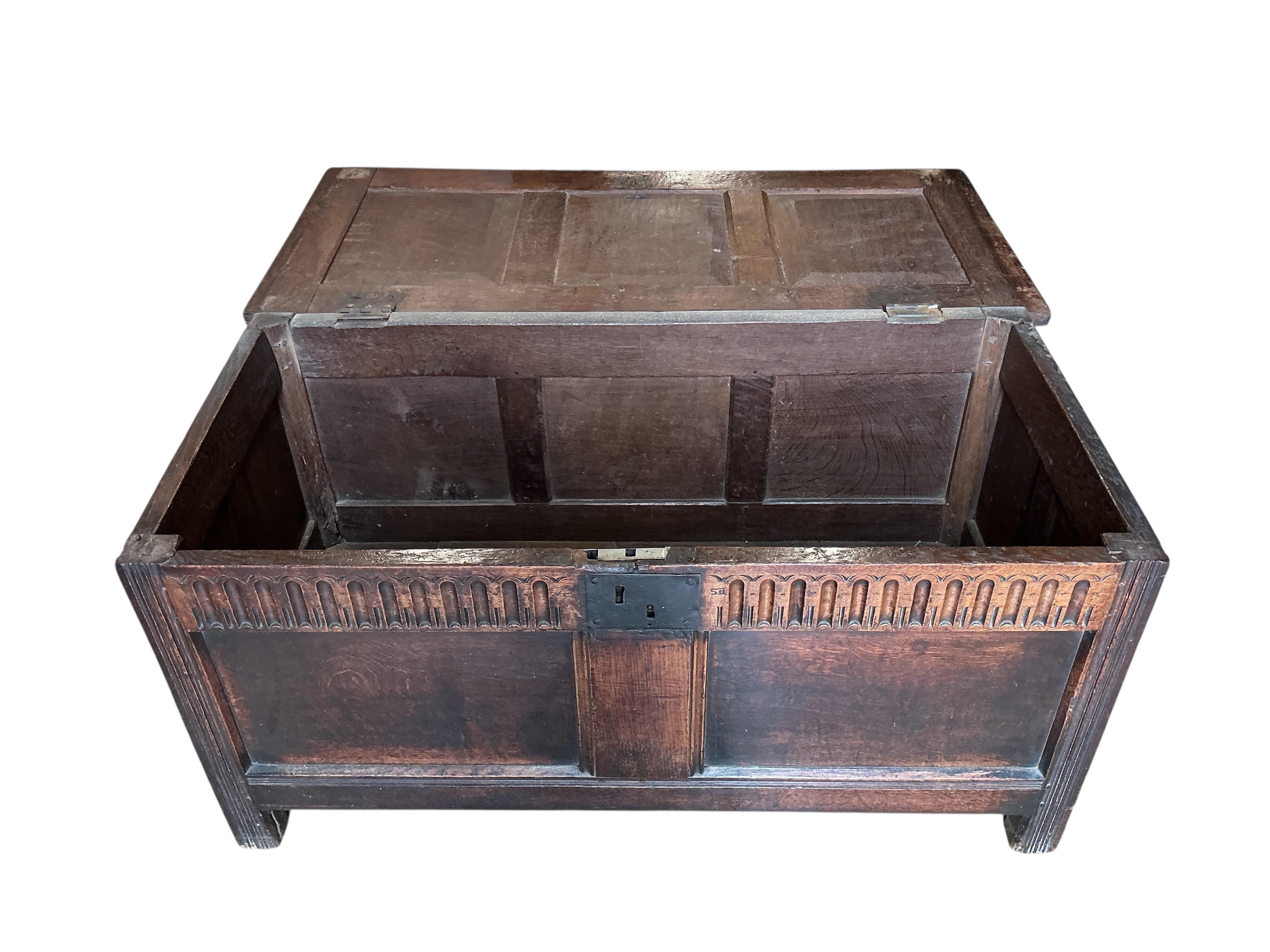A 17th century panelled oak coffer, width 121cm, depth 57cm, height 58cm